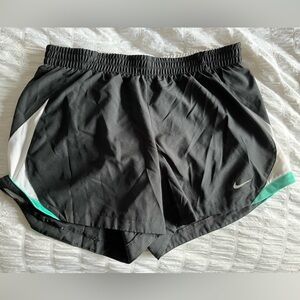 Black, turquoise blue-green, and white Nike running shorts